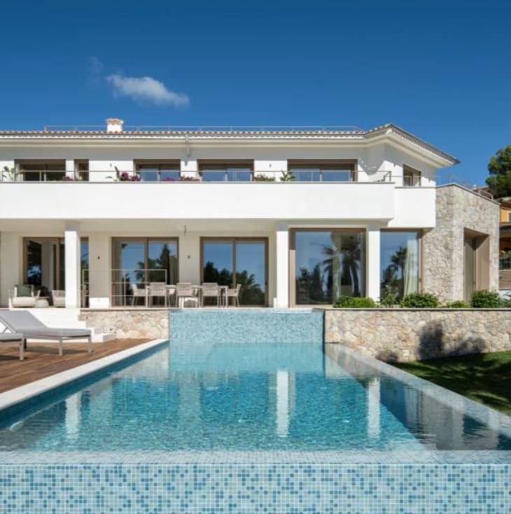 Luxury property with pool complex and upstairs balcony terrace.