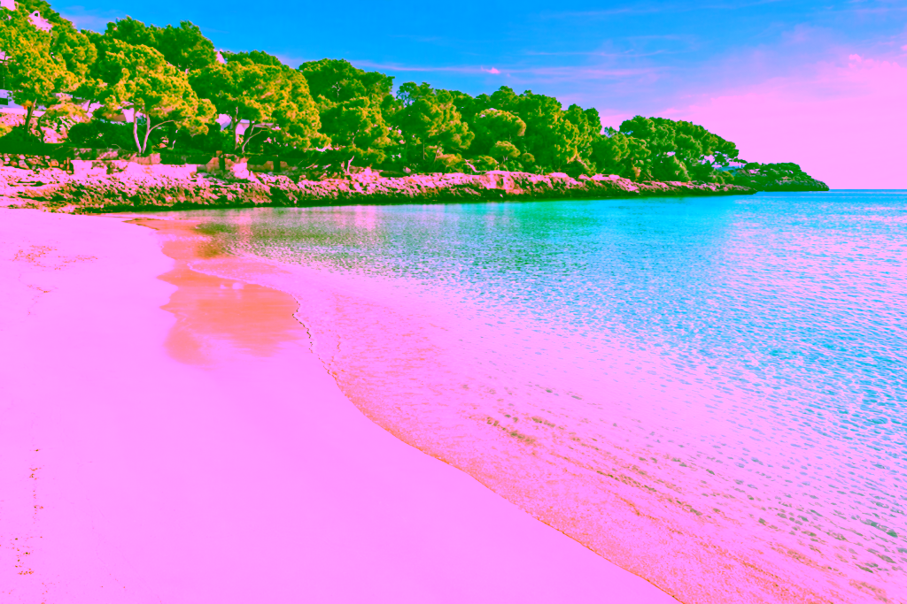 Fine sandy beach with crystal-clear, turquoise sea and rocky coast with pine trees